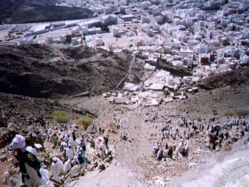 View of the city Mecca from the Mount Hira and the pilgrims climbing to the mount.
