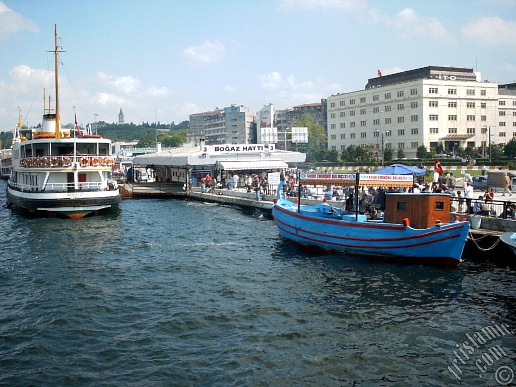 View of Eminonu shore, jetty, ship and fisherman`s boat from the sea in Istanbul city of Turkey.
