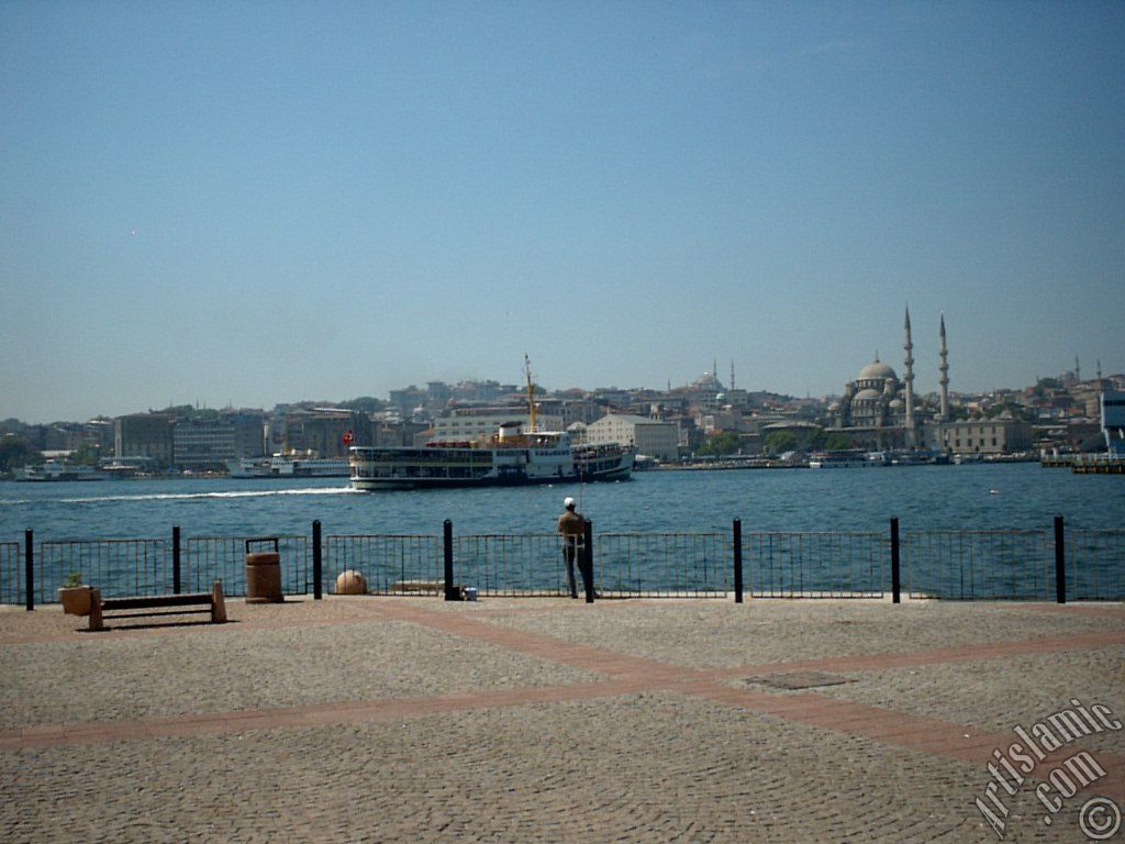 View of fishing man, Eminonu coast, Sultan Ahmet Mosque (Blue Mosque) and Yeni Cami (Mosque) from the shore of Karakoy in Istanbul city of Turkey.
