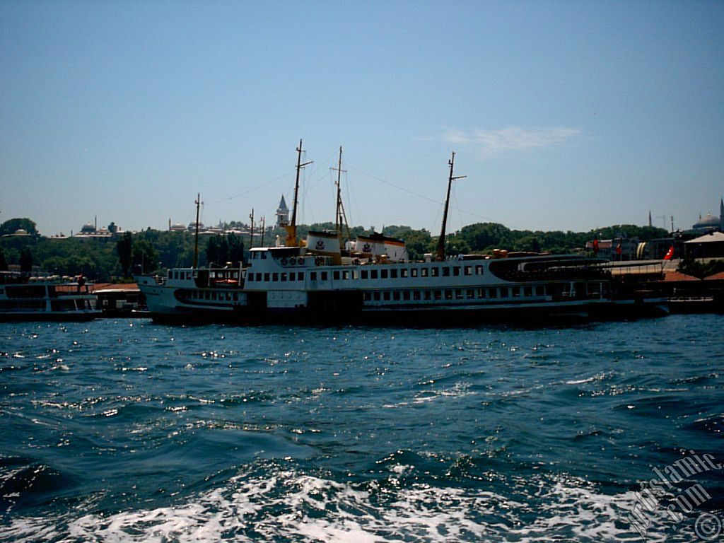 View of Eminonu coast, ships and Topkapi Palace from the sea in Istanbul city of Turkey.
