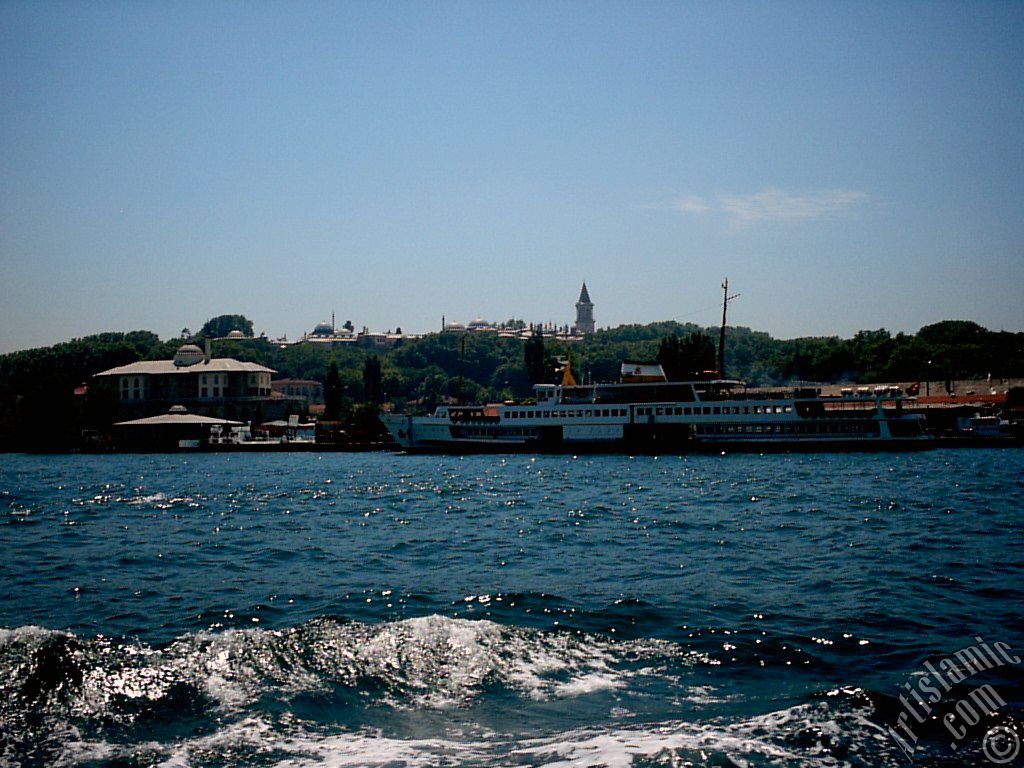 View of Eminonu coast, ships and Topkapi Palace from the sea in Istanbul city of Turkey.
