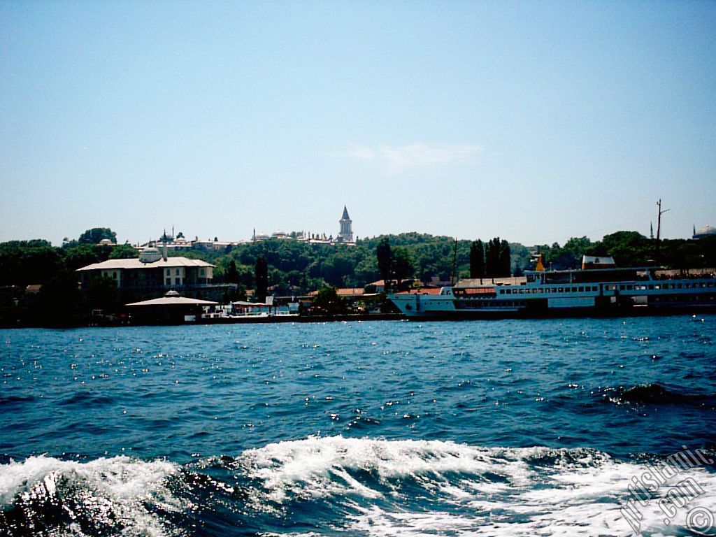 View of Eminonu coast, ships and Topkapi Palace from the sea in Istanbul city of Turkey.
