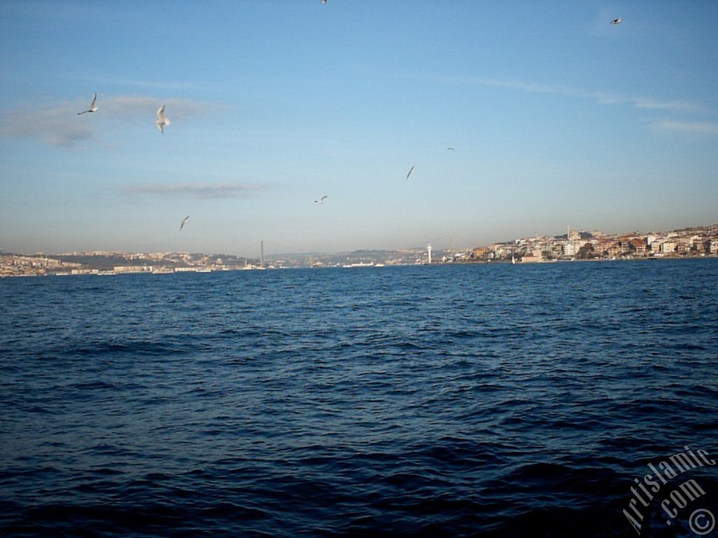 View of Bosphorus Bridge, Uskudar coast and Kiz Kulesi (Maiden`s Tower) from the Bosphorus in Istanbul city of Turkey.
