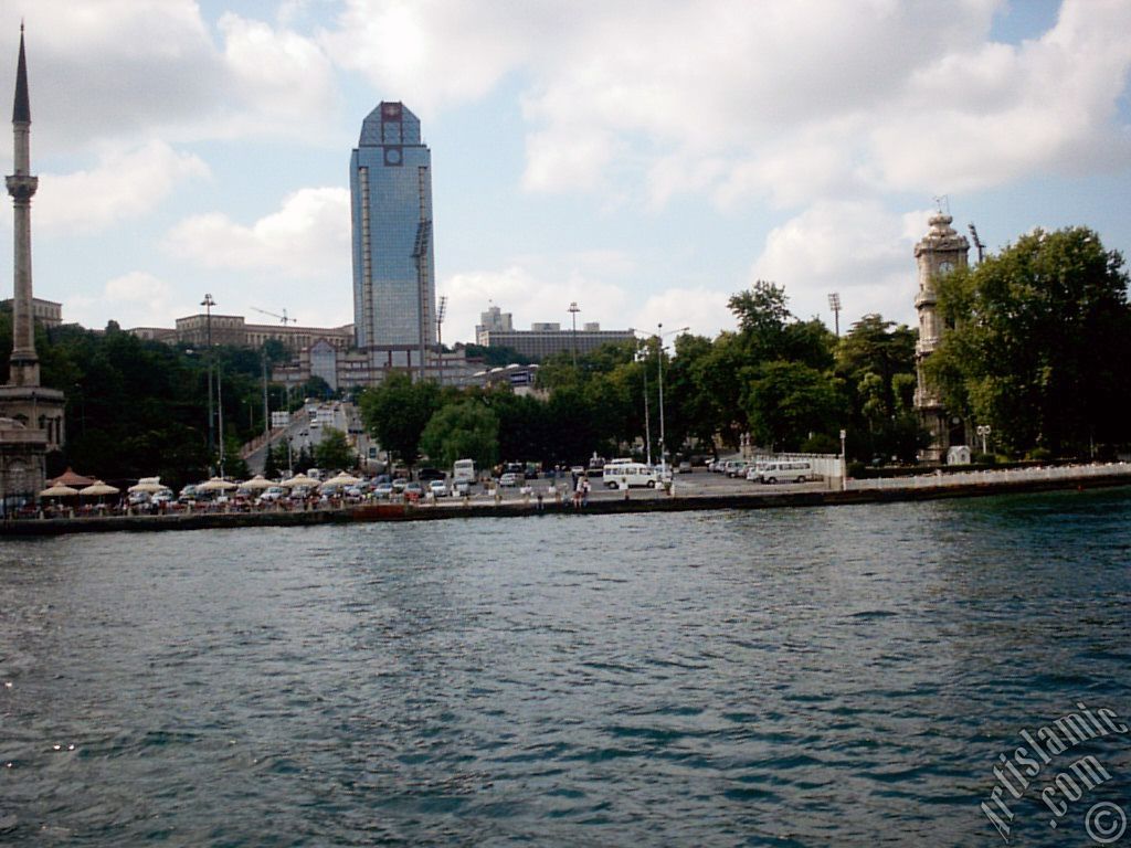 View of Dolmabahce coast, Valide Sultan Mosque and clock tower from the Bosphorus in Istanbul city of Turkey.
