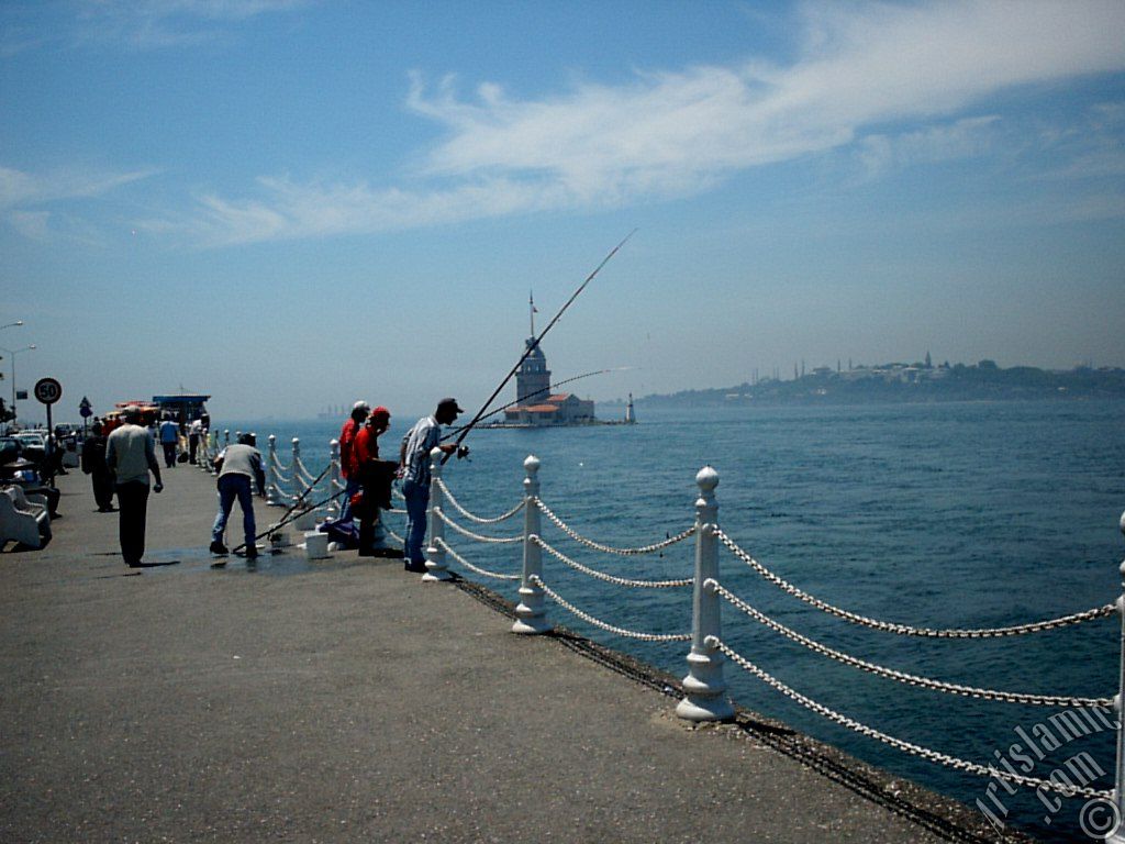 View of fishing people and Kiz Kulesi (Maiden`s Tower) from Uskudar shore of Istanbul city of Turkey.
