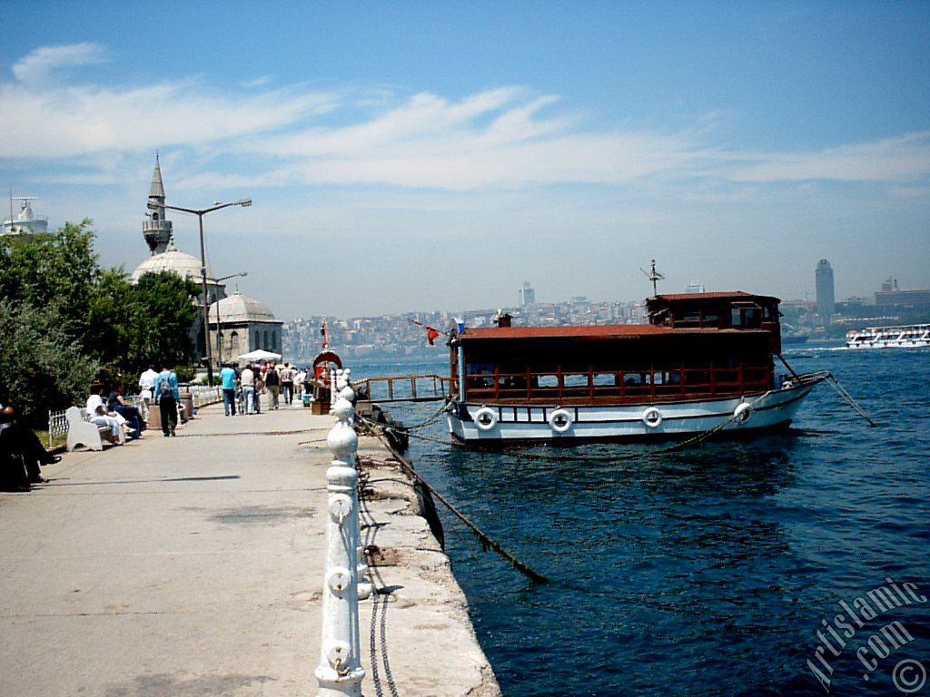 View of the shore, a fisher boat and Semsi Pasha Mosque in Uskudar district of Istanbul city of Turkey.
