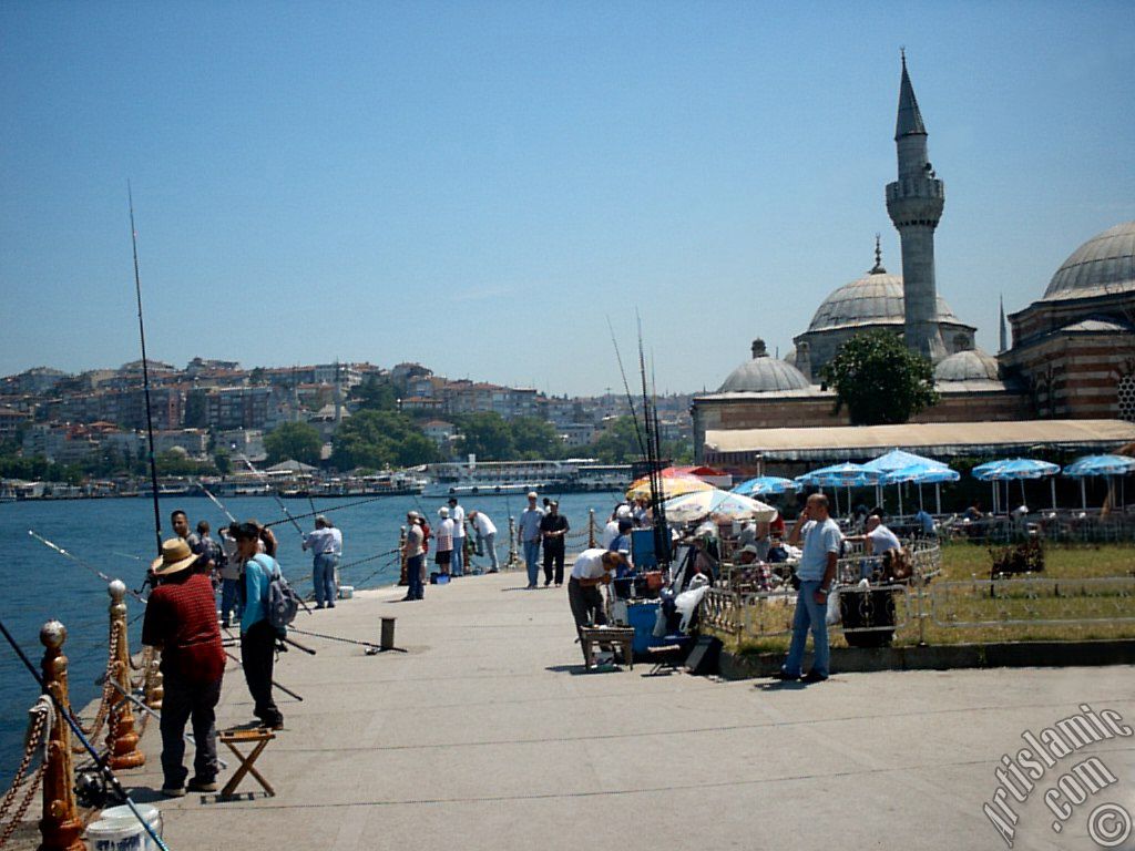 View of fishing people and Semsi Pasha Mosque made by Architect Sinan in Uskudar shore of Istanbul city of Turkey.
