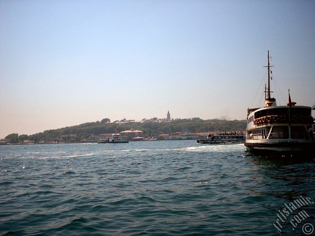 View of a ship waiting at Karakoy jetty and Topkapi Palace from the shore of Karakoy in Istanbul city of Turkey.
