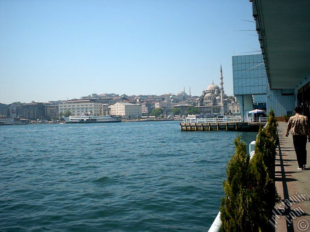 View of Eminonu coast, Sultan Ahmet Mosque (Blue Mosque) and Yeni Cami (Mosque) from under the Galata Bridge in Istanbul city of Turkey.
