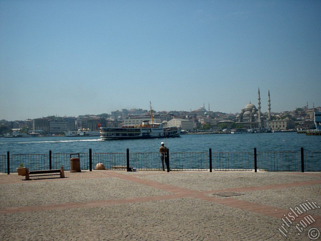 View of fishing man, Eminonu coast, Sultan Ahmet Mosque (Blue Mosque) and Yeni Cami (Mosque) from the shore of Karakoy in Istanbul city of Turkey.

