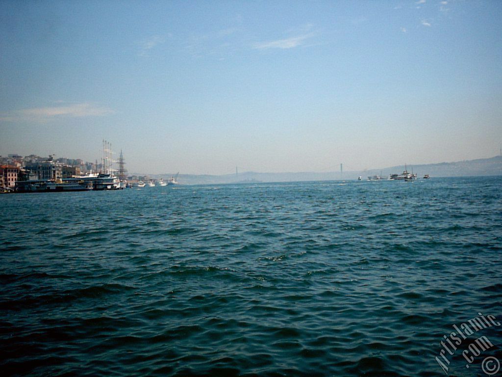 View towards Bosphorus, on the left Karakoy shore and on the horizon the Bosphorus Bridge from under Galata Bridge located in Istanbul city of Turkey.
