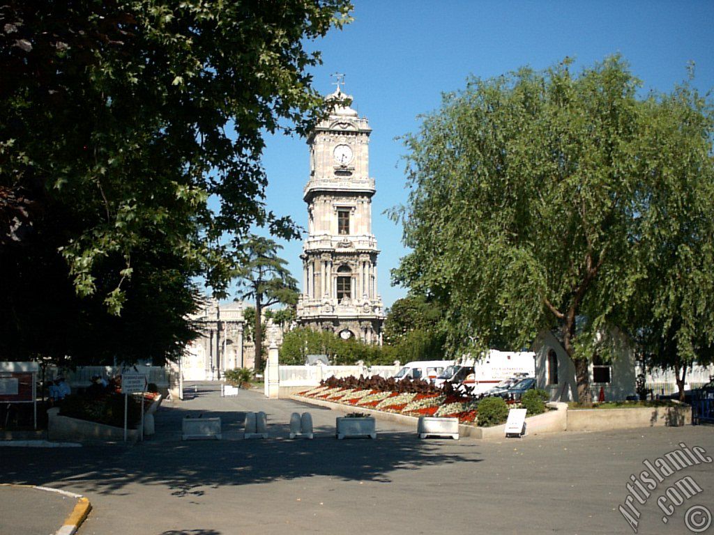 View of Dolmabahce Palace`s entrance and clock tower located in Dolmabahce district in Istanbul city of Turkey.

