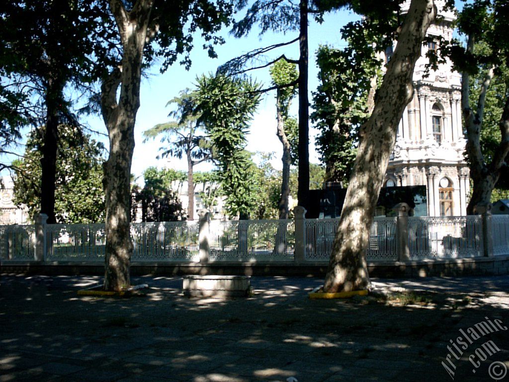 View of Dolmabahce Palace`s entrance and clock tower located in Dolmabahce district in Istanbul city of Turkey.
