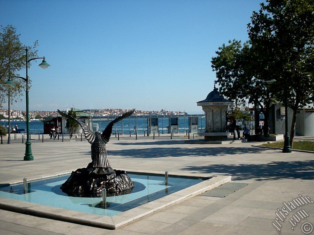 View of a park on the shore of Besiktas district and the coast of Uskudar on the horizon in Istanbul city of Turkey.
