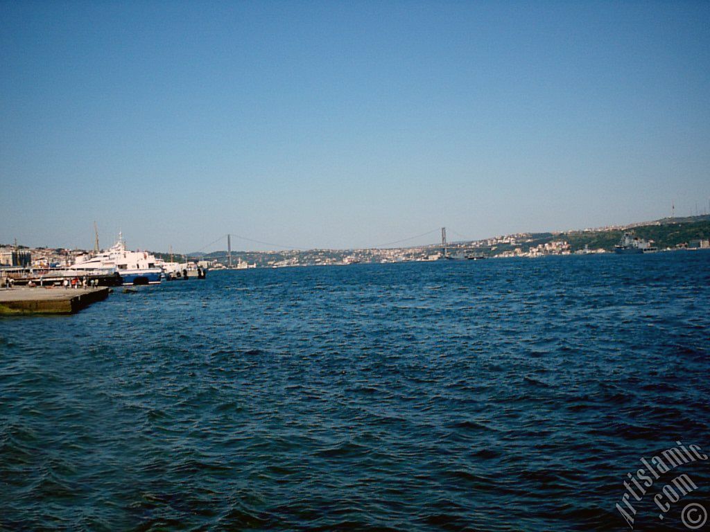 View towards jetty, Bosphorus Bridge and Uskudar coast from a park at Kabatas shore in Istanbul city of Turkey.
