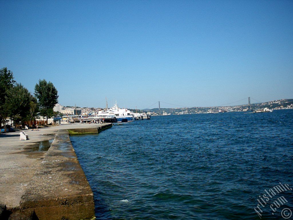 View towards jetty, Bosphorus Bridge and Uskudar coast from a park at Kabatas shore in Istanbul city of Turkey.

