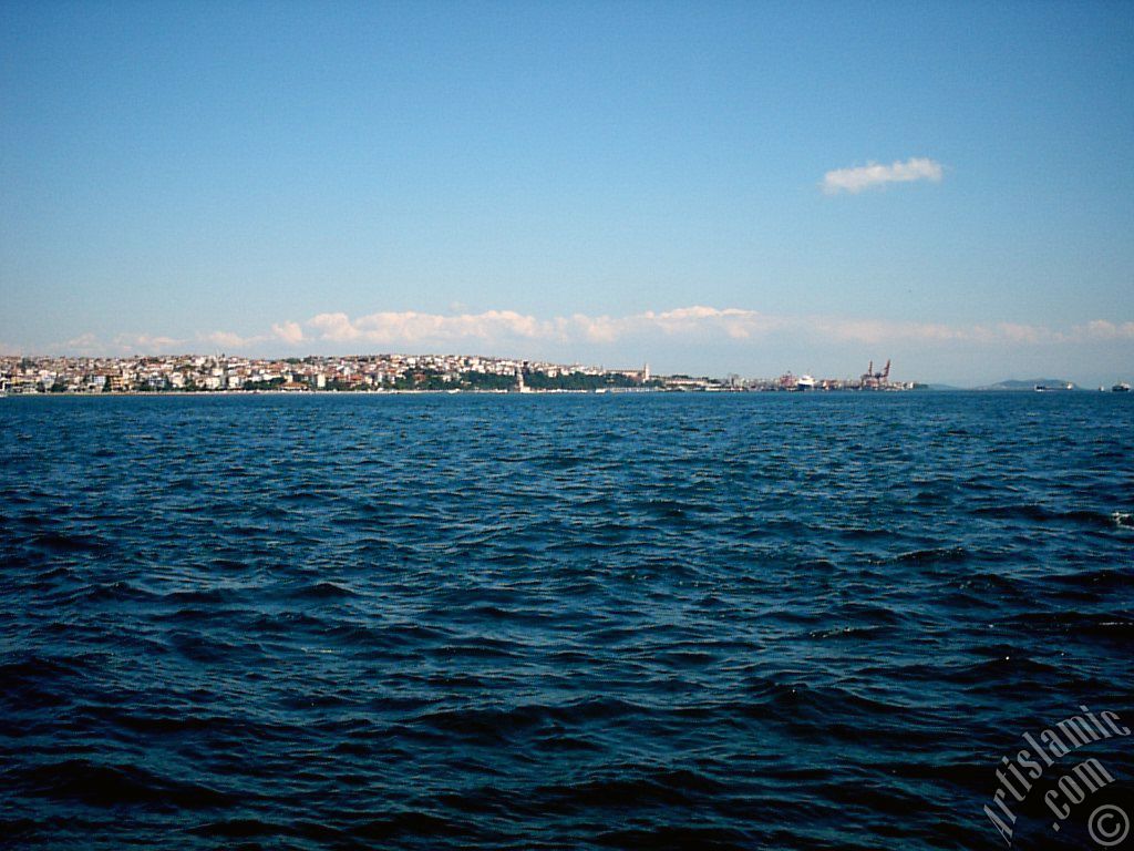 View towards Kiz Kulesi (Maiden`s Tower) and Uskudar-Harem coast from a park at Kabatas shore in Istanbul city of Turkey.
