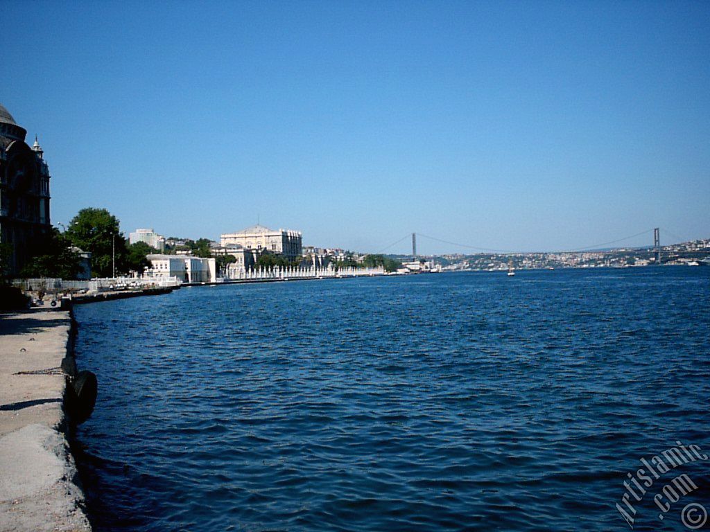 View of the Valide Sultan Mosque, Dolmabahce Palace, Bosphorus Bridge and Uskudar coast from a park at Dolmabahce shore in Istanbul city of Turkey.
