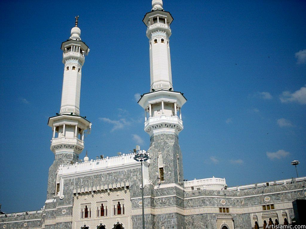 The minarets rising over the walls of the Masjed al-Haraam where is the Holy Kabah located in it.
